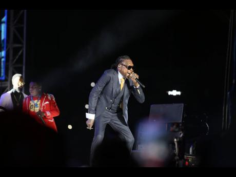 Vybz Kartel owning the stage in a sharp three-piece suit at Freedom Street—proving the 'Teacha' never left the class! 🎤🔥